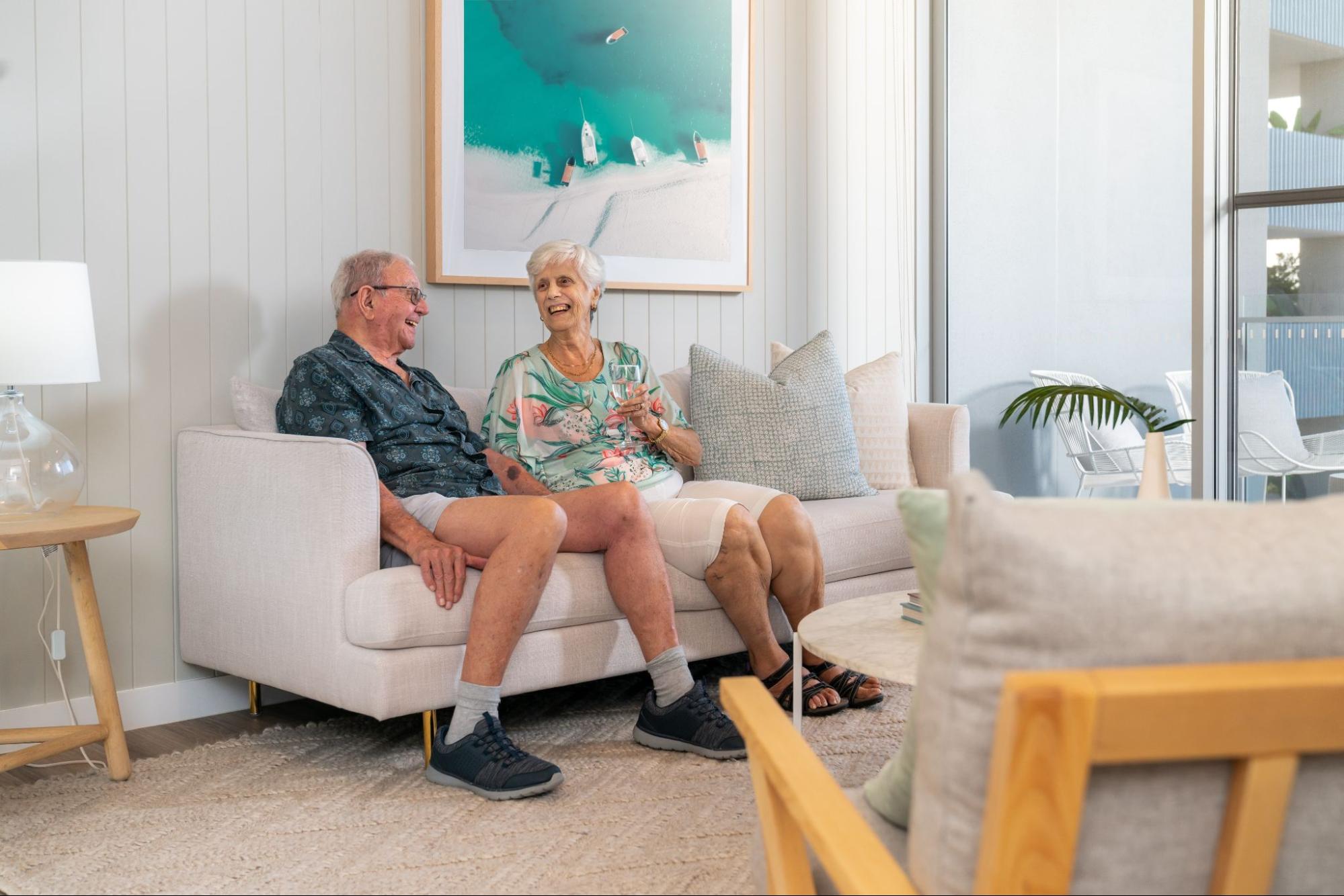 Older man and woman sitting on a couch